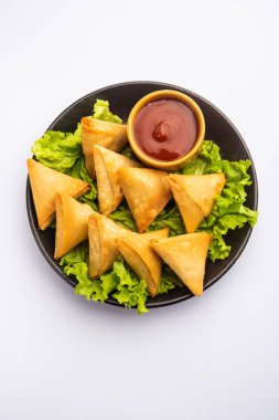 cocktail mini triangle samosa made using patti or strip, popular home made snack from India