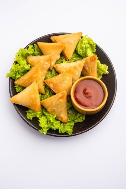 cocktail mini triangle samosa made using patti or strip, popular home made snack from India