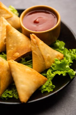 cocktail mini triangle samosa made using patti or strip, popular home made snack from India
