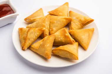 cocktail mini triangle samosa made using patti or strip, popular home made snack from India