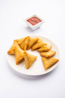 cocktail mini triangle samosa made using patti or strip, popular home made snack from India