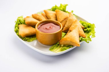 cocktail mini triangle samosa made using patti or strip, popular home made snack from India