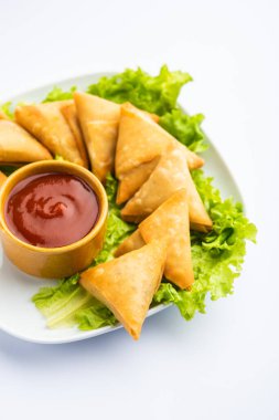 cocktail mini triangle samosa made using patti or strip, popular home made snack from India