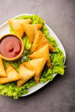 cocktail mini triangle samosa made using patti or strip, popular home made snack from India