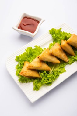 cocktail mini triangle samosa made using patti or strip, popular home made snack from India