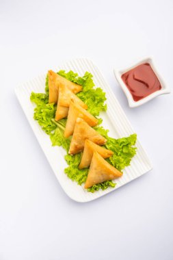 cocktail mini triangle samosa made using patti or strip, popular home made snack from India