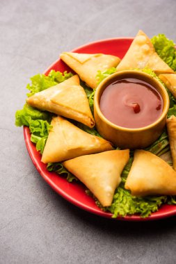 cocktail mini triangle samosa made using patti or strip, popular home made snack from India