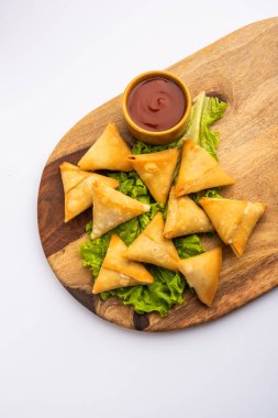 cocktail mini triangle samosa made using patti or strip, popular home made snack from India
