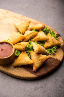 cocktail mini triangle samosa made using patti or strip, popular home made snack from India