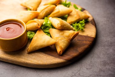 cocktail mini triangle samosa made using patti or strip, popular home made snack from India
