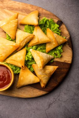 cocktail mini triangle samosa made using patti or strip, popular home made snack from India