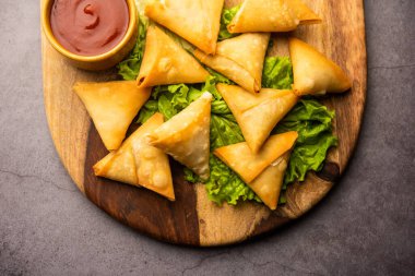 cocktail mini triangle samosa made using patti or strip, popular home made snack from India