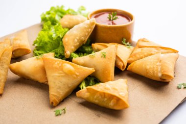 cocktail mini triangle samosa made using patti or strip, popular home made snack from India