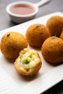 jalapeno cheese balls or poppers served with tomato ketchup