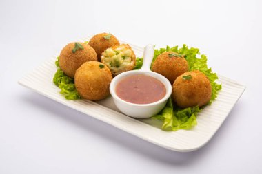 jalapeno cheese balls or poppers served with tomato ketchup