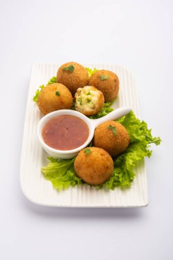 jalapeno cheese balls or poppers served with tomato ketchup