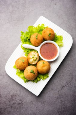 jalapeno cheese balls or poppers served with tomato ketchup