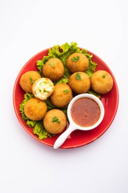 jalapeno cheese balls or poppers served with tomato ketchup clipart