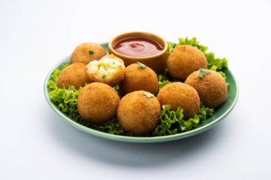 jalapeno cheese balls or poppers served with tomato ketchup