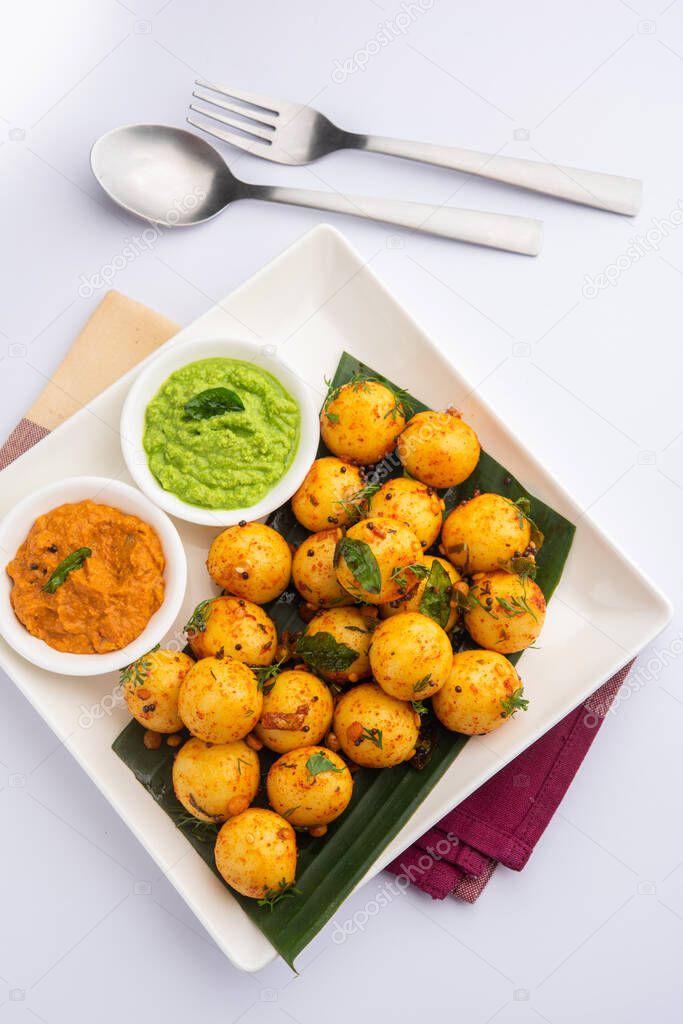 Soft and spongy Idli balls or goli idly with green and red chutney, south indian food recipe