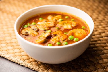 Mushroom and Pea Curry with Roasted Garlic, Indian food served in a bowl