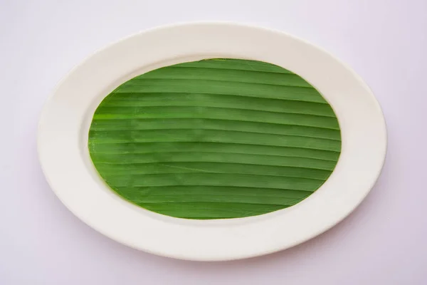 banana leaf on blank plate for edit food or subject on