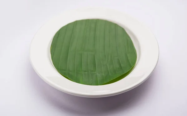 banana leaf on blank plate for edit food or subject on