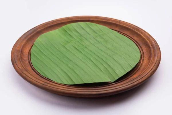 banana leaf on blank plate for edit food or subject on