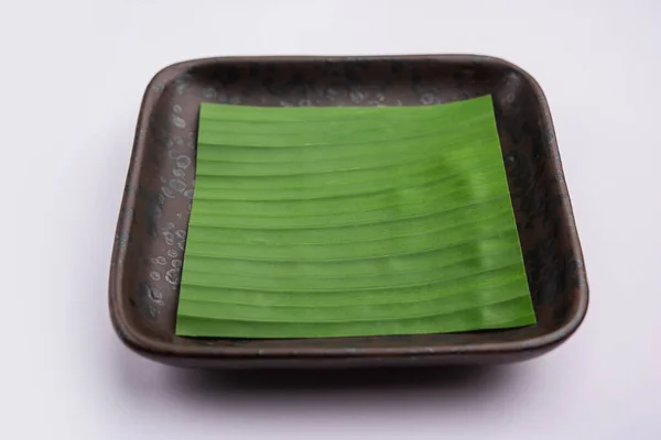 banana leaf on blank plate for edit food or subject on