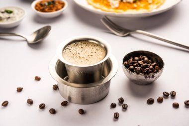 South Indian Filter coffee served in a traditional brass or stainless steel cup clipart