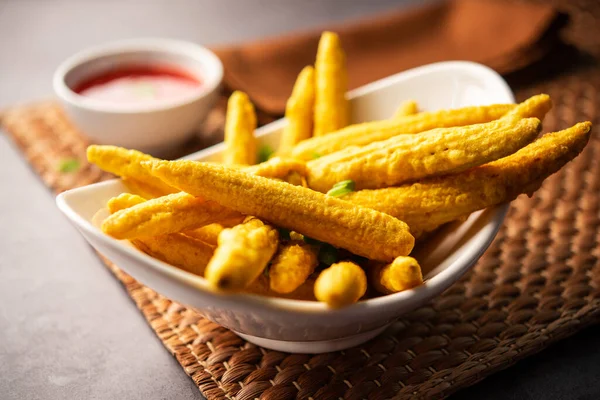 Crispy fried baby corn pakoda, pakora  or Baby corn fritters served with ketchup, Indian food