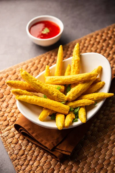 Crispy fried baby corn pakoda, pakora  or Baby corn fritters served with ketchup, Indian food