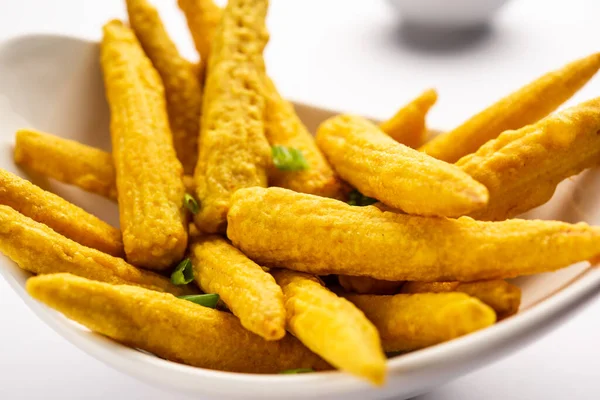 Crispy fried baby corn pakoda, pakora  or Baby corn fritters served with ketchup, Indian food