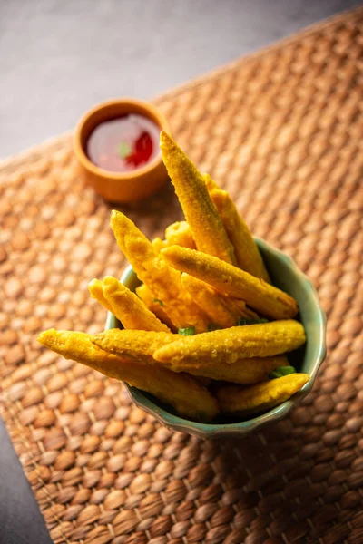 Crispy fried baby corn pakoda, pakora  or Baby corn fritters served with ketchup, Indian food