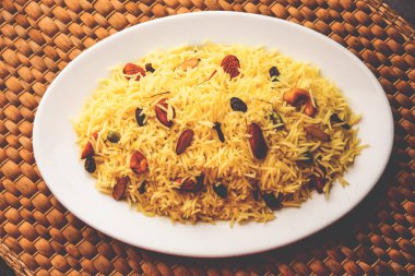 Kashmiri sweet modur pulao made of rice cooked with sugar, water flavored with Saffron and dry fruits