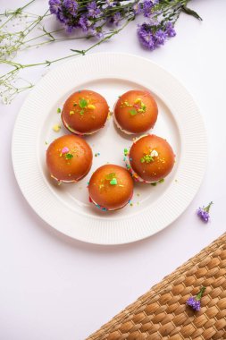 Malai Chop or Cream sandwich made using filling Rasgulla or Gulab jamun sweet is a Bengali sweet