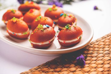 Malai Chop or Cream sandwich made using filling Rasgulla or Gulab jamun sweet is a Bengali sweet
