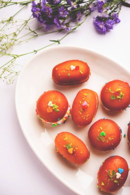 Malai Chop or Cream sandwich made using filling Rasgulla or Gulab jamun sweet is a Bengali sweet