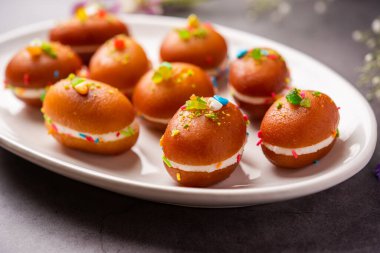 Malai Chop or Cream sandwich made using filling Rasgulla or Gulab jamun sweet is a Bengali sweet