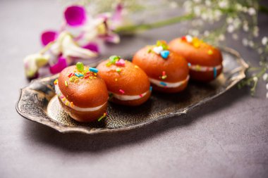 Malai Chop or Cream sandwich made using filling Rasgulla or Gulab jamun sweet is a Bengali sweet