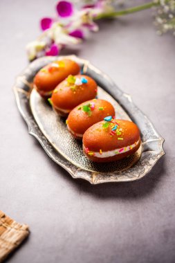 Malai Chop or Cream sandwich made using filling Rasgulla or Gulab jamun sweet is a Bengali sweet