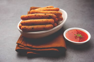 crispy Rava Aloo fingers or Potato semolina fried finger sticks served with ketchup