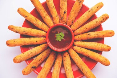 crispy Rava Aloo fingers or Potato semolina fried finger sticks served with ketchup