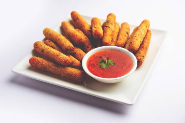 crispy Rava Aloo fingers or Potato semolina fried finger sticks served with ketchup