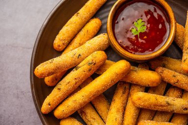 crispy Rava Aloo fingers or Potato semolina fried finger sticks served with ketchup