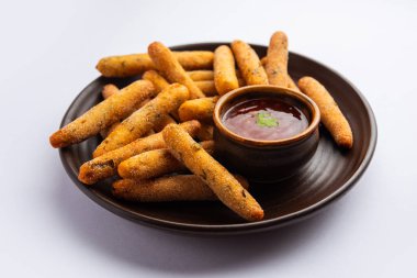 crispy Rava Aloo fingers or Potato semolina fried finger sticks served with ketchup