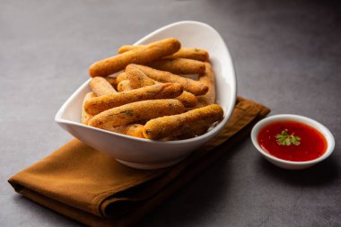 crispy Rava Aloo fingers or Potato semolina fried finger sticks served with ketchup