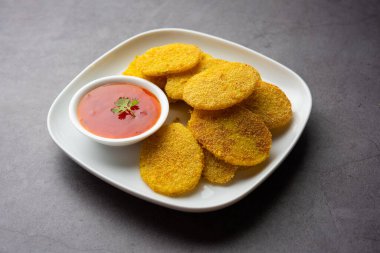 crispy potato rava fried slices or batatyache kaap or batata semolina fry snacks from India