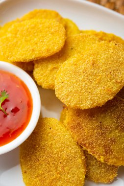 crispy potato rava fried slices or batatyache kaap or batata semolina fry snacks from India
