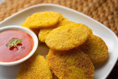 crispy potato rava fried slices or batatyache kaap or batata semolina fry snacks from India
